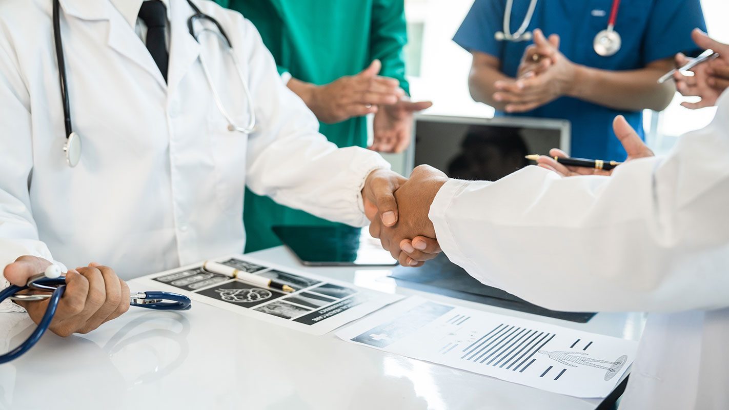 medical-professionals-shaking-hands-2 photograph of medical professionals shaking hands