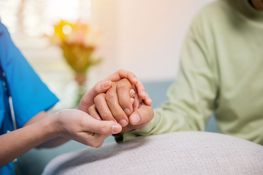 provider-and-patient-holdind-hands Wound Logix image of provider holding hands with a patient